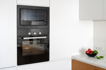 Modern built in oven with closed glass door on white kitchen