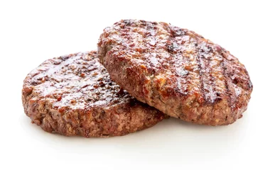 Foto op Canvas two piece of grilled ground beef meat for hamburger © Pineapple studio