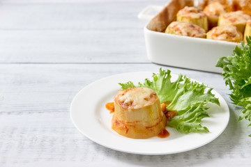 Zucchini stuffed with minced meat, vegetables and salad.