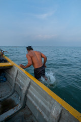 Obraz premium A Fisherman Jumping into the Water to Check His Nets, Jaffna, Sri Lanka