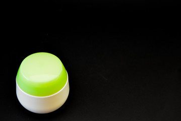 A bottle of household chemicals cosmetics on a black background neck of a bottle close up macro...