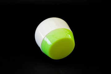 A bottle of household chemicals cosmetics on a black background neck of a bottle close up macro pattern