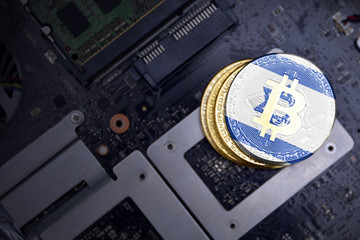 golden bitcoins with flag of israel on a computer electronic circuit board. bitcoin mining concept.