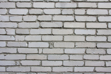 Stary, zniszczony mur z szarych cegieł - tło w stylu wabi-sabi