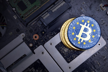 golden bitcoins with flag of european union on a computer electronic circuit board. bitcoin mining...