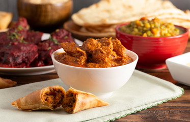 Dinner Set with Chicken Tikka Massala on a Wooden Table