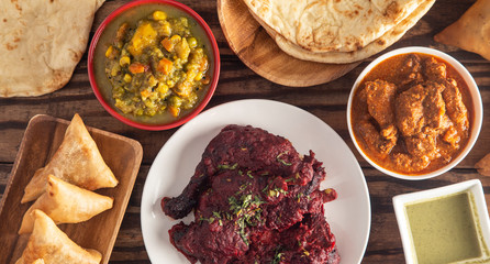 A Table Set with a Dinner of Various Curry Dishes on a Rustic Wooden Table