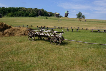 Old cart. Ukrainian Selsk carriage of the nineteenth century. Summer landscape, sunshine. Village Pirogovo.