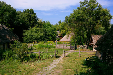 Old Ukrainian house. Ukrainian hut of the nineteenth century. Summer landscape, flowers in front of...
