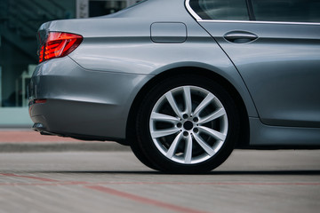 Modern sedan car rear wheel and rim