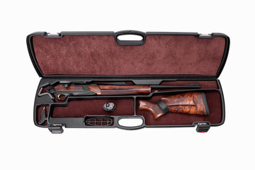Modern semi-automatic hunting rifle with a wooden butt in an open plastic case. Isolate on a white background.