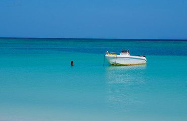 Small boat anchor in the Mexican gulf turquoise and clear water