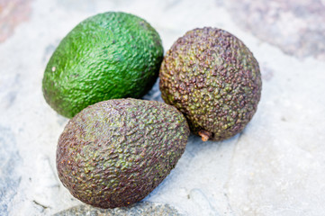 Three ripe avocado fruits close-up