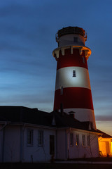 lighthouse on the sea at sunset