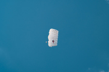 White parachute in blue sky