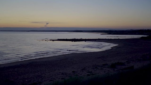 Time lapse shot of tides rising at dusk on the beach in Sweden. Vejbystrand.