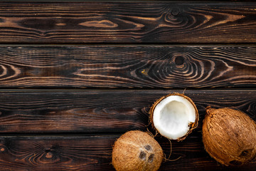 Fototapeta na wymiar Coconut for cosmetic in body treatment concept on wooden background top view copyspace