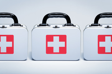 First aid kits in a row on light grey background
