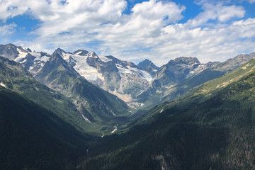 Panorama of mountains scene with dramatic blue sky in national park of Dombay