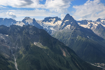Panorama of mountains scene with dramatic blue sky in national park of Dombay