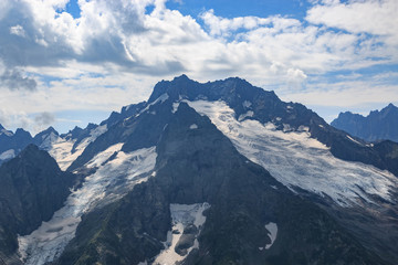 Panorama of mountains scene with dramatic blue sky in national park of Dombay