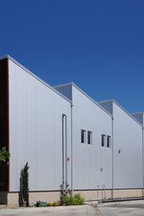 Sectional view of a modern industrial warehouse under deep blue sky