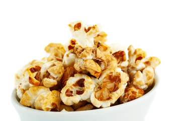 Sweet popcorn in ceramic bowl on white background