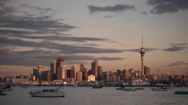 Day to night time lapse of the Auckland City skyline from Northcote Point across the Waitemata Harbour, New Zealand.