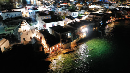 Obraz premium Aerial drone night shot from iconic illuminated main town of Mykonos island, Cyclades, Greece