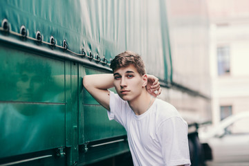 Stylish hipster man in the at the city in a white t-shirt 