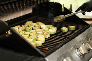 Delicious zucchini bbq, sliced zucchini on top of grill, street food, close up photo