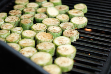 Delicious zucchini bbq, sliced zucchini on top of grill, street food, close up photo
