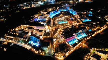 Aerial drone night shot from iconic illuminated main town of Mykonos island, Cyclades, Greece