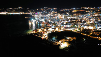 Aerial drone night shot from iconic illuminated main town of Mykonos island, Cyclades, Greece