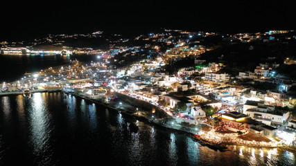 Aerial drone night shot from iconic illuminated main town of Mykonos island, Cyclades, Greece