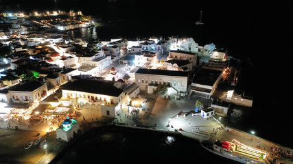 Fototapeta na wymiar Aerial drone night shot from iconic illuminated main town of Mykonos island, Cyclades, Greece