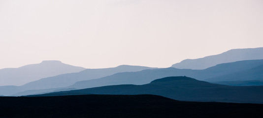 Isle of Skye - misty island landscape - hills silhouette covered in mist