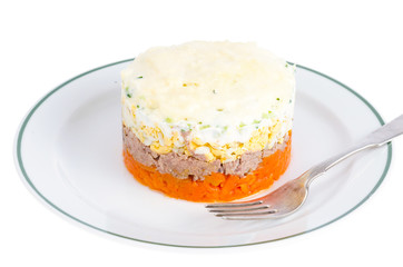 Portion layered salad with fish, carrots and eggs. 