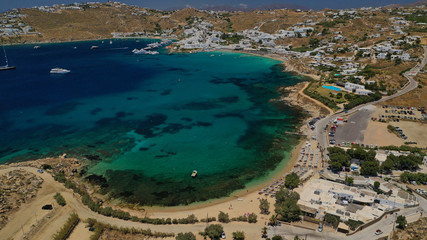 Aerial drone bird's eye view from famous beach of Paraga and Agia Anna featuring iconic Skorpios club and Santa Anna with largest pool in Europe, Mykonos island, Cyclades, Greece