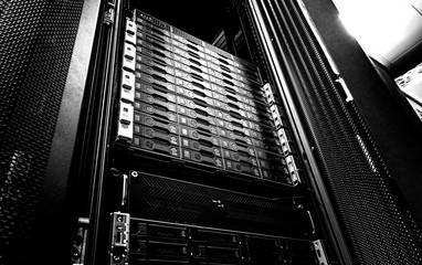Blade server in rack cluster hard drives storage in internet data center room black and white tone