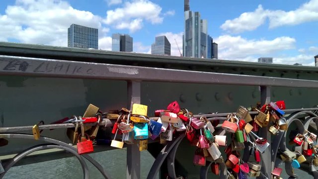 View of colorful locks of love on the Eiserner Steg (Iron Bridge) over the Main river in Frankfurt, July 2019