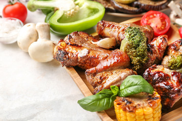 Plate with tasty grilled meat and vegetables on table