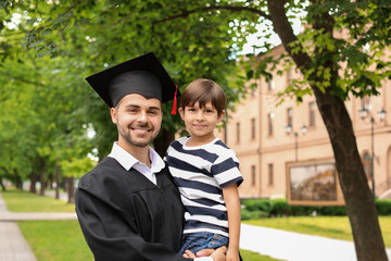 Man with his little son on graduation day