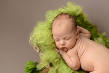 Sleeping newborn baby on a brown background 