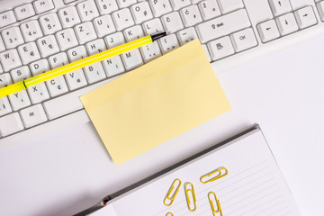 Empty orange square papers by the pc keyboard with copy space.