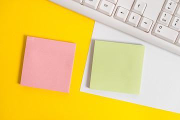 Empty blank paper with copy space and pc keyboard above orange background table.