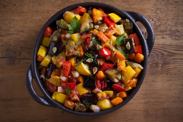 Vegetable stew: aubergines, paprika pepper, tomatoes, zucchini, carrots and onions. Stewed vegetable salad. View from above, top studio shot