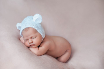 Ten days old newborn baby girl sleeping on a pink blanket.