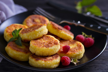 Cottage cheese pancakes. Syrniki and raspberries