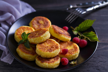 Cottage cheese pancakes. Syrniki and raspberries